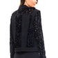 Woman wearing a black floral-patterned jacket.