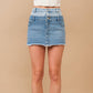 Woman wearing a two-tone denim skirt.