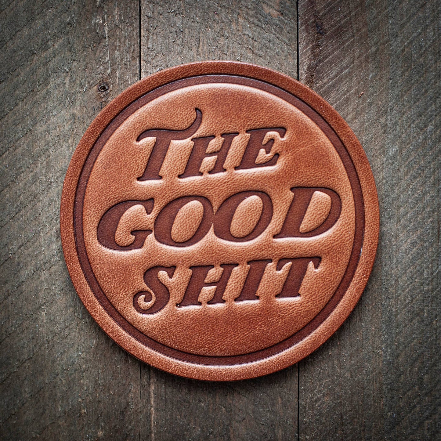 Leather coaster with THE GOOD SHIT text.
