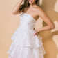 Woman in a white, strapless, tiered dress.