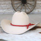 White cowboy hat with red band.
