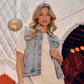 Woman in denim vest and t-shirt.