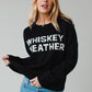 Woman in black Whiskey Weather sweater.