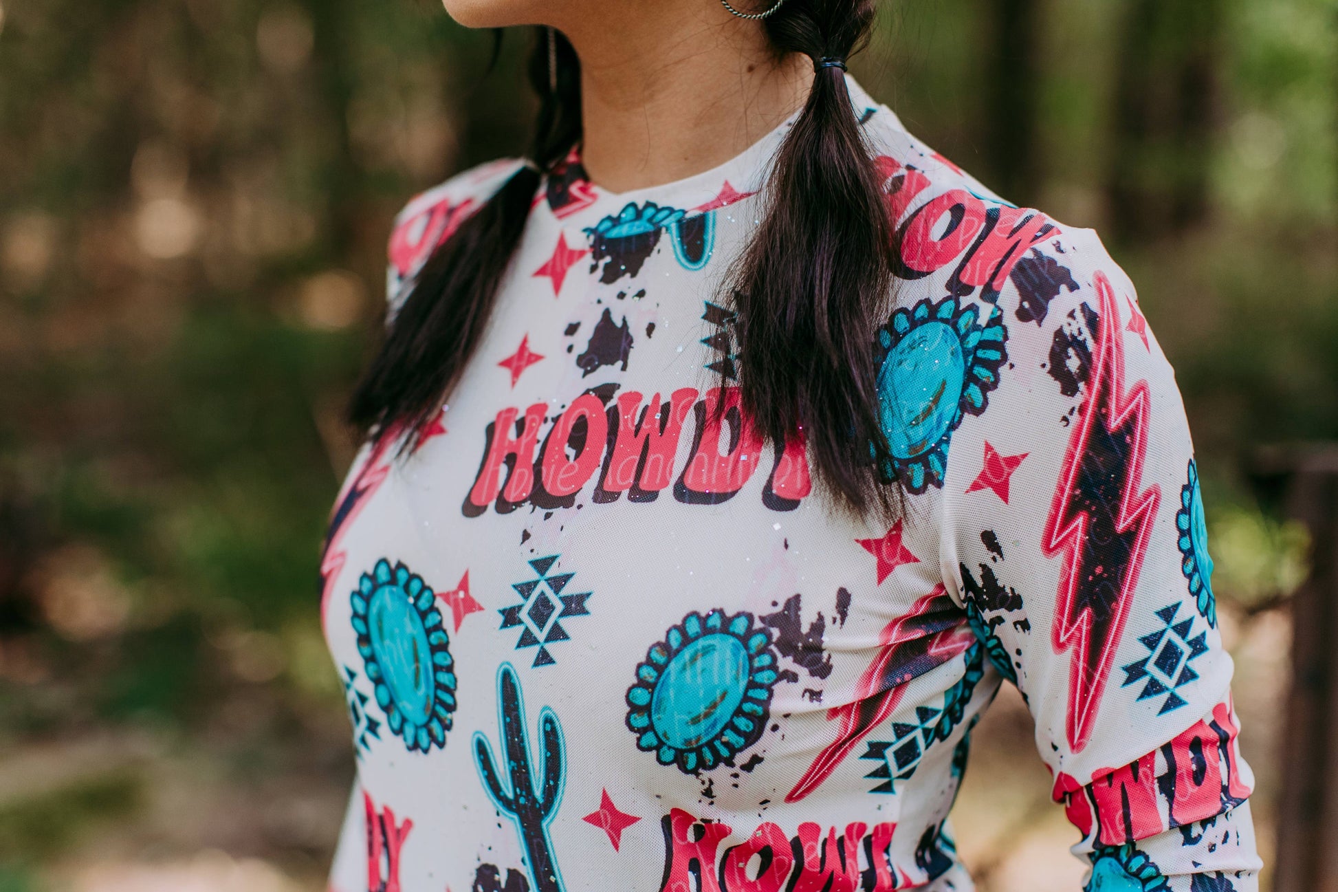 Woman wearing a white shirt with a Howdy print.