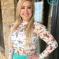 Woman wearing western print top