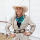 Woman wearing fringe scarf & cowboy hat with vintage horse design