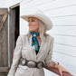 Woman in cowboy hat and fringe scarf, vintage horse style