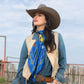 Cowgirl in royal blue vintage horse scarf and hat.