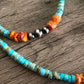 Turquoise beaded necklace with orange and silver accents.