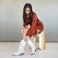 Woman in dress and Lexington ceramic crackle boots