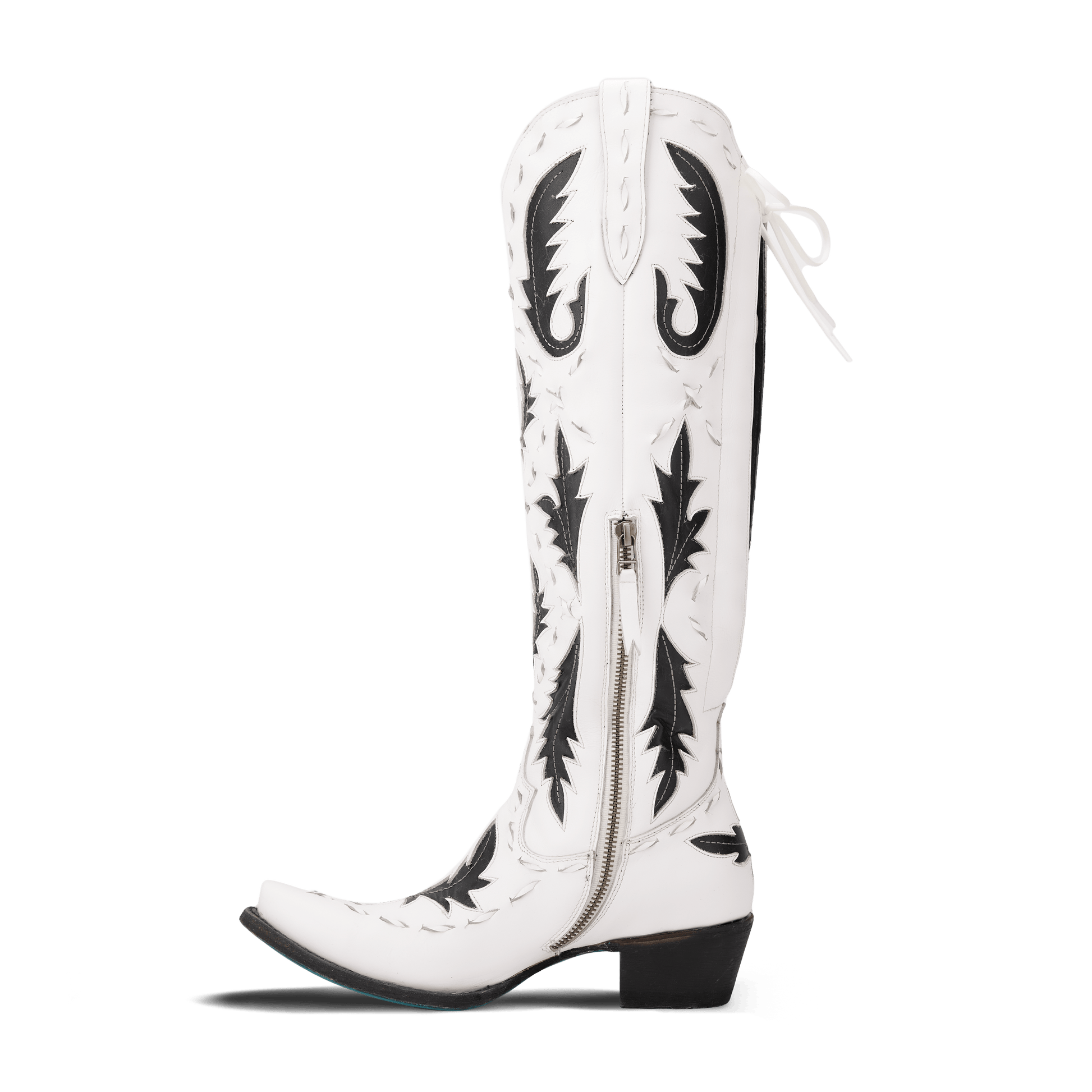 White and black Reverie cowboy boot on newsprint