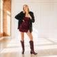Woman in black blazer and Reverie black cherry dress and boots