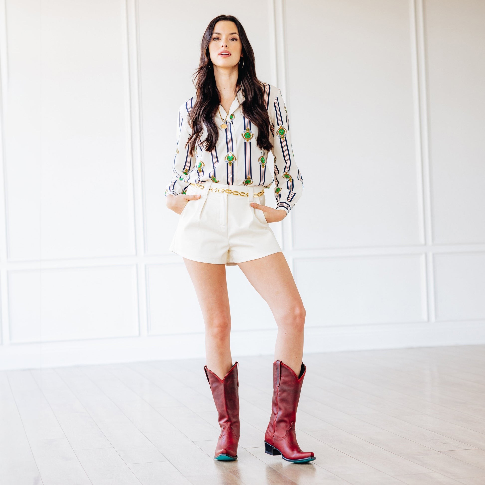 Emma Jane in Smoldering Ruby boots and white shorts.