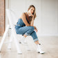 Woman in denim & white boots, smokeshow bootie photo by Matthew White