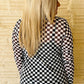 Woman wearing a checkered top, round the track style