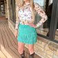 Woman in turquoise fringe skirt and cowboy top