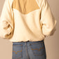 Woman wearing cream fleece jacket and jeans