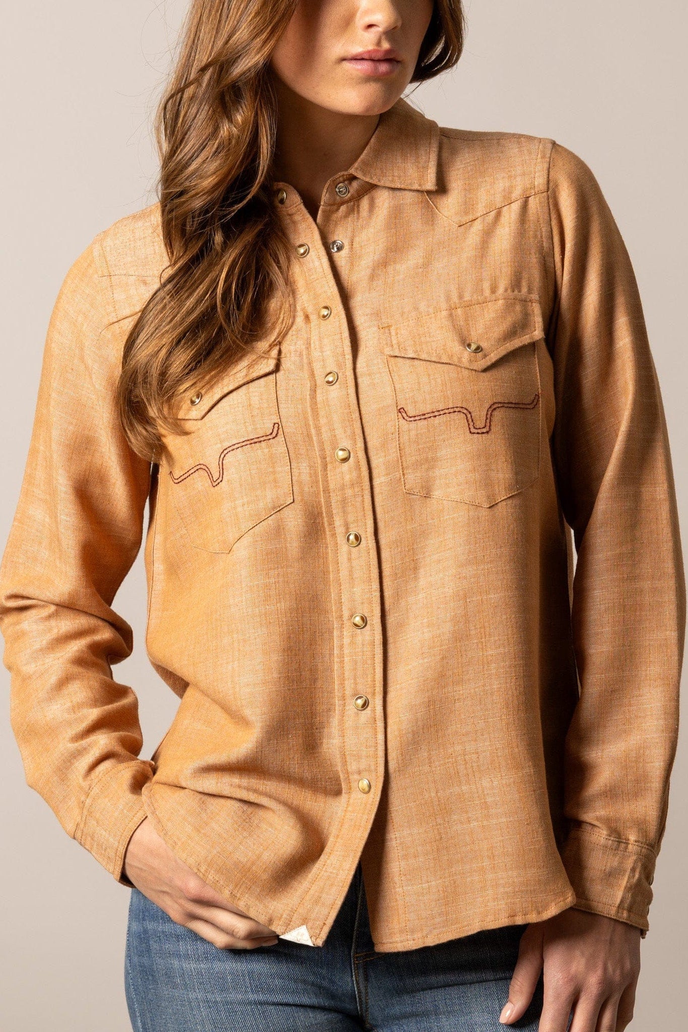 Woman wearing tan button-up shirt (unnamed-222)