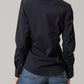 Woman in black button-down shirt and jeans