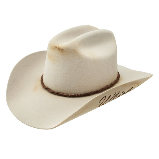 Vintage cream-colored cowboy hat with Wild West inscription.