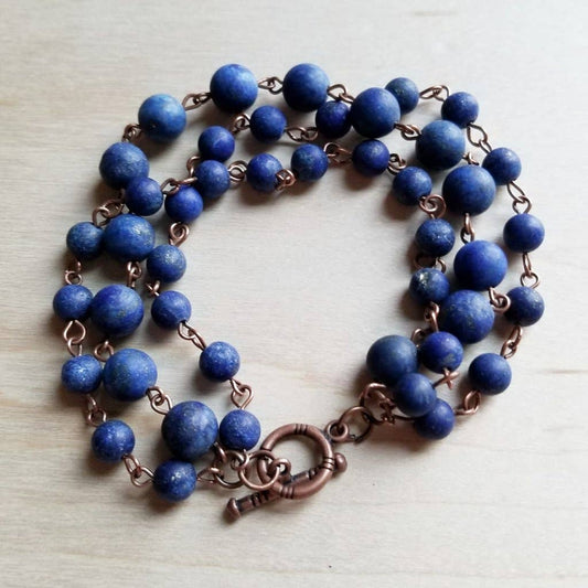 Blue beaded bracelet with copper chain.