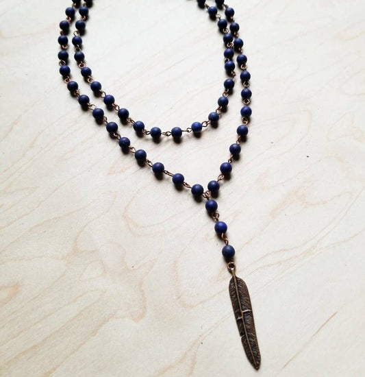Two-strand beaded necklace with feather pendant.