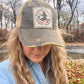 Woman wearing a baseball cap with a patch.