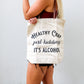 Woman holding Healthy Crap alcohol tote bag