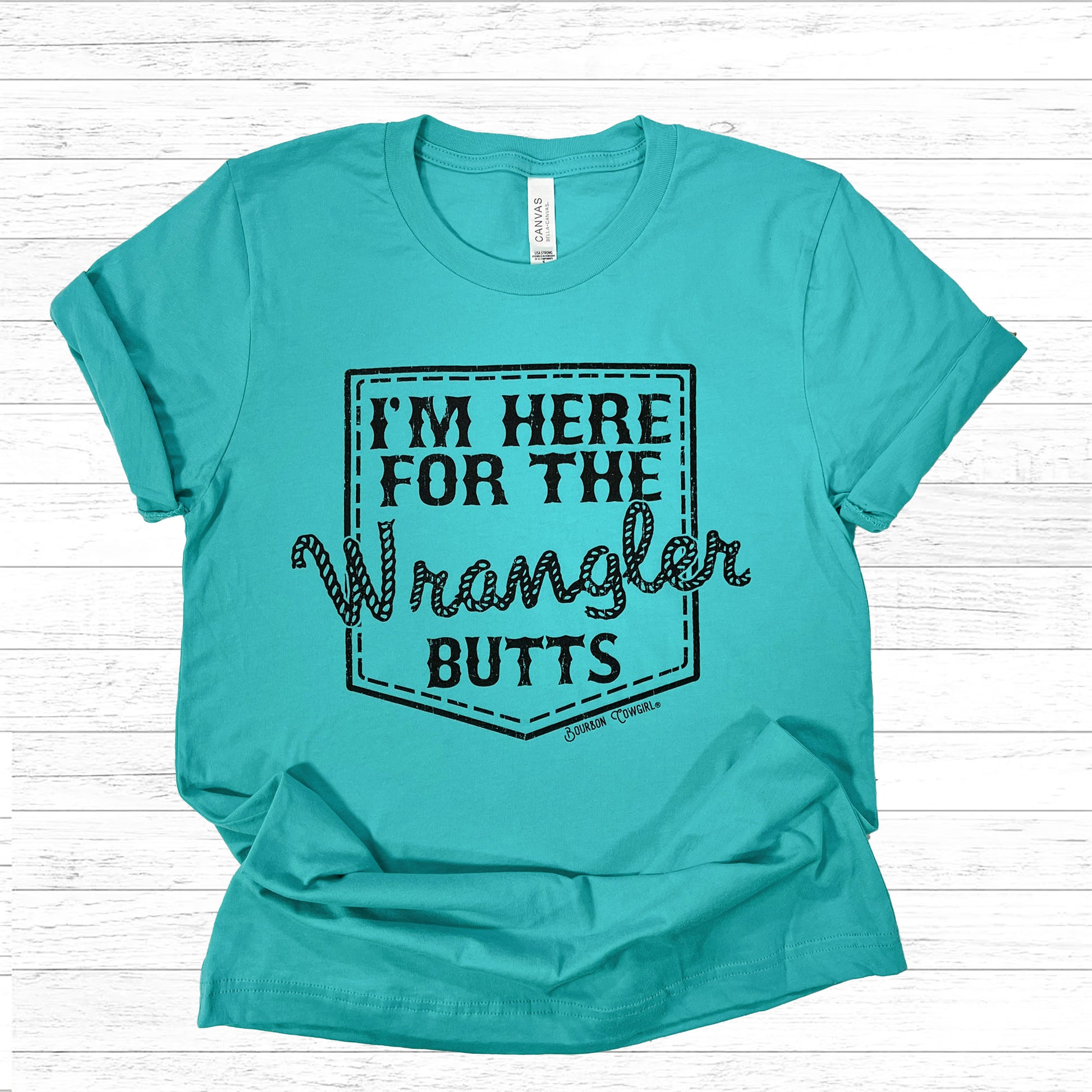 Teal I'm Here For The Wrangler Butts shirt on beadboard