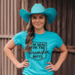 Woman in turquoise Wrangler Butts tee and cowboy hat